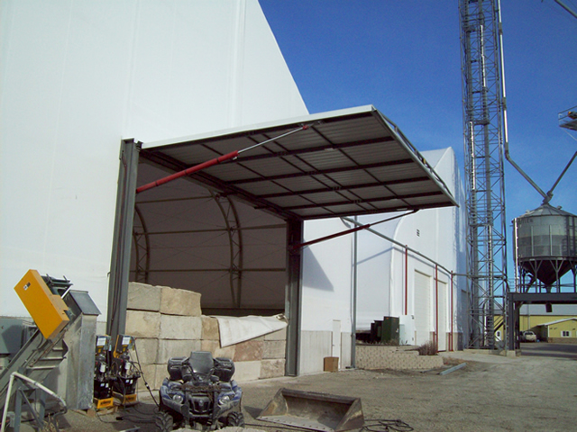 side view of open hydraulic door on fabric building