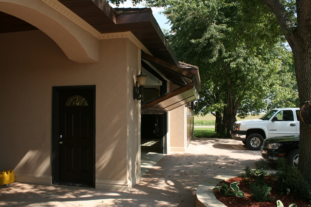 Two bifold garage doors with wood paneling