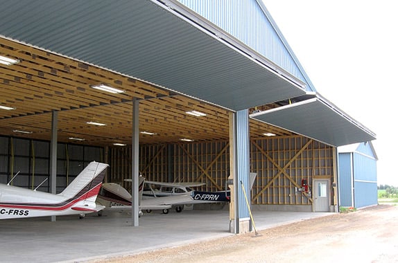 Hangar with four 46' x 15' Schweiss liftstrap bifold doors
