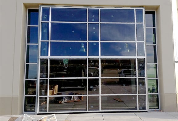 Schweiss bifold door with black liftstraps looks like any other window panel