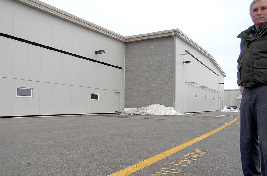 Clean 48 foot bifold hangar door at airport in Minnesota