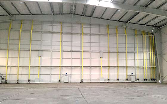 33,000 lb hangar door is raised by twelve Schweiss patented straplifts