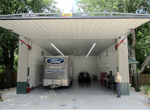 Schweiss One-Piece hydraulic door opens up to racing trailer, and room for a larger trailer or motorhome.