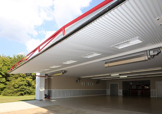 Schweiss One-Piece Hydraulic Door provides a nice shaded canopy and insulated to retrofitted hangar