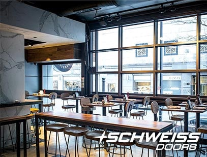 Schweiss hydraulic door fits into the look of the dining area