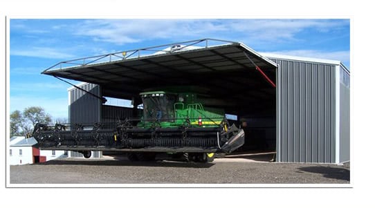 machine shed with large combine exiting through Hydraulic Door