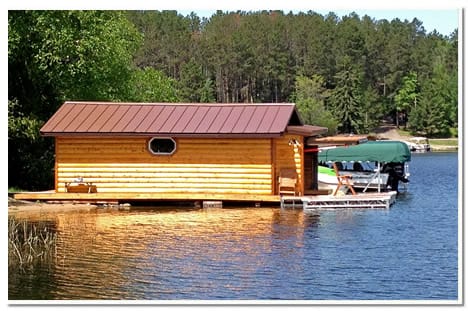Revamped boathouse show the log cladding and Schweiss hydraulic door