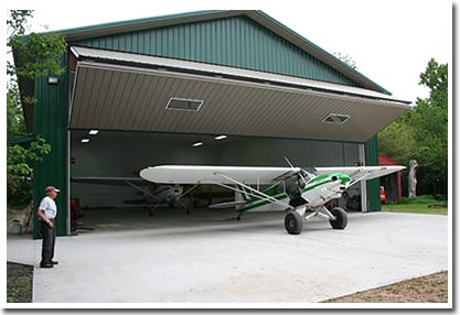 Schweiss Liftstrap bifold door helps Gene get his three planes into his machine shed fast.