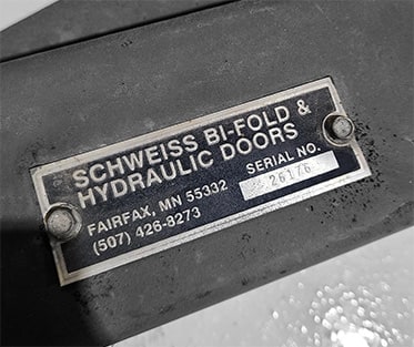 Closeup view of what a Schweiss serial number plate looks like for reference