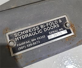 Closeup view of what a Schweiss serial number plate looks like for reference