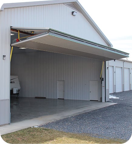 Schweiss Lift Straps on bifold door of white farm shop