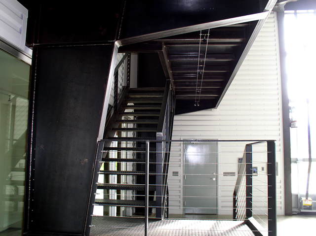 metal stairway in hangar with glass bifold door