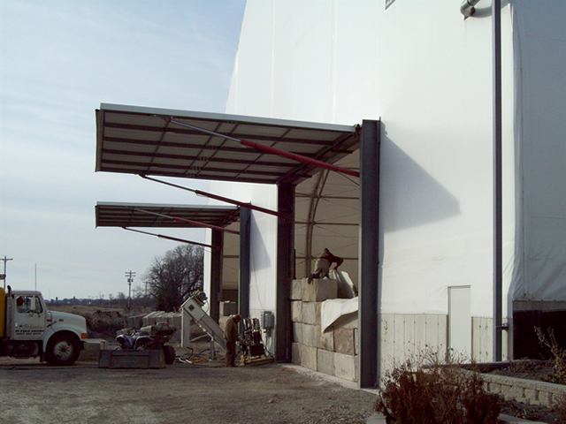 twin hydraulic doors on fabric building endwall in open position