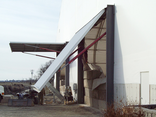 two hydraulic doors on fabric building one open one half open