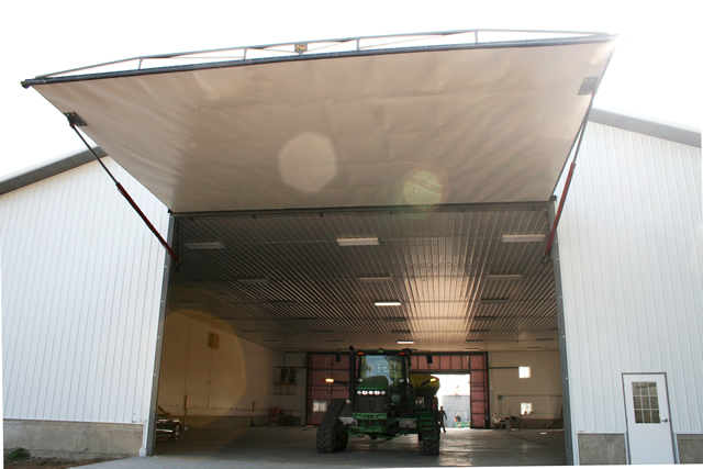 Large hydraulic door opens farm machine shed