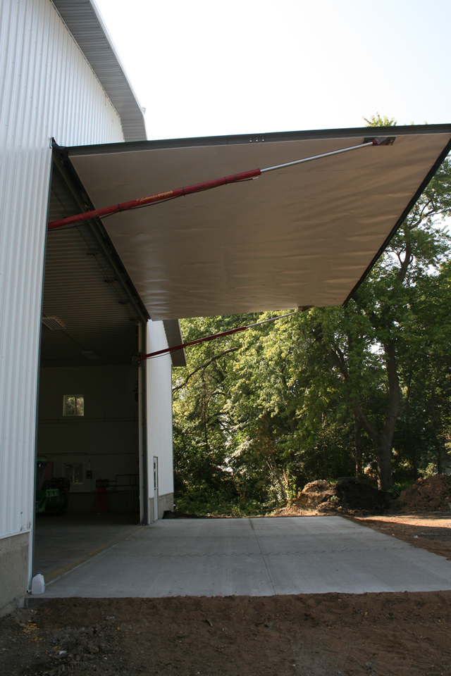 hydraulic door in full open position on large ag shop