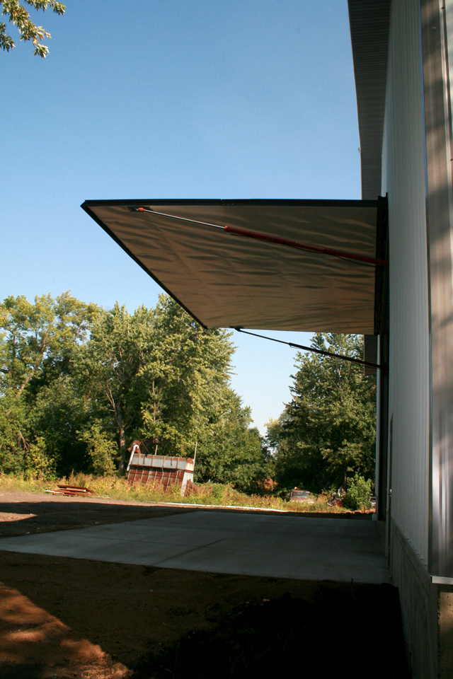 Side view fully open hydraulic door on machine shed