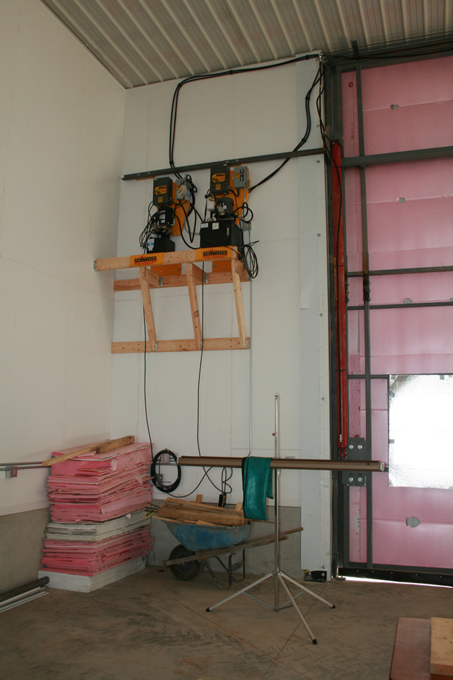 Twin hydraulic door pumps mounted high on wall