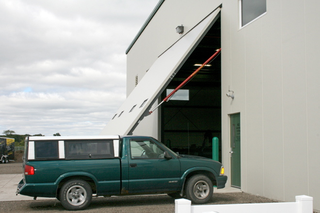 Large hydraulic door on equipment dealership