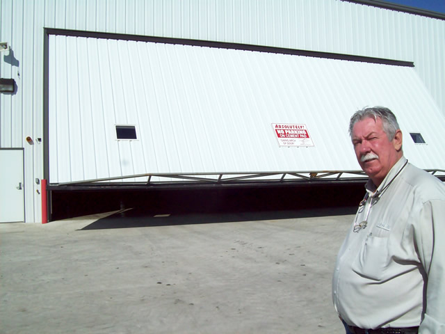 Hydraulic door on equipment dealership's machine shop