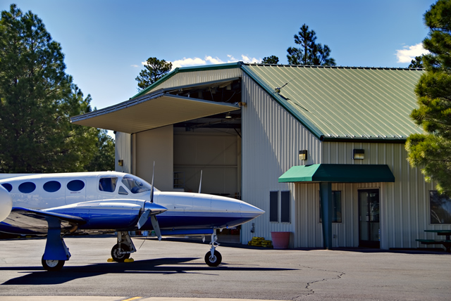 bifold door in open position on steel aircraft hangar building