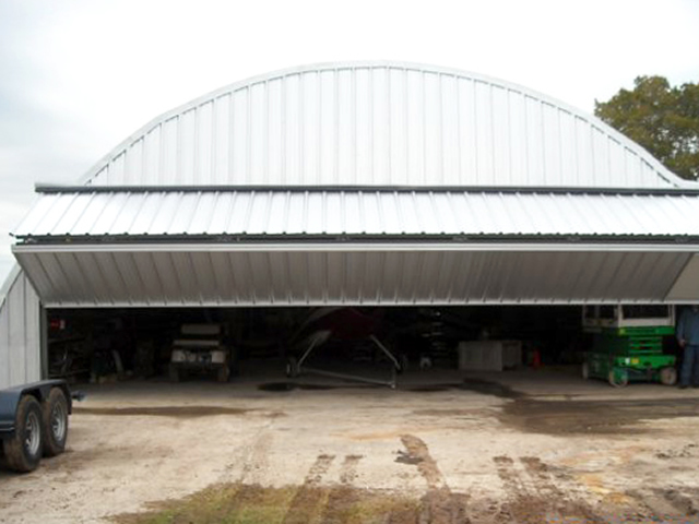 bifold door opening attached to free standing header on quonset building