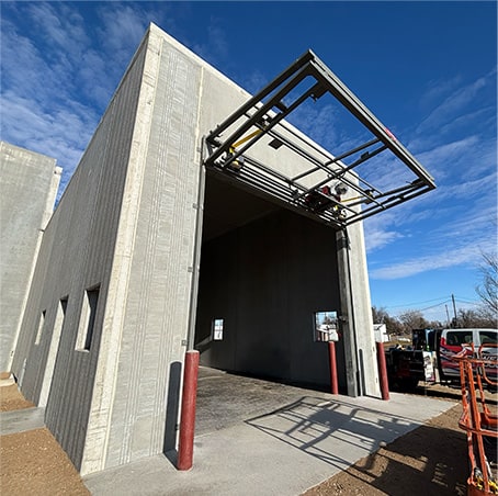 Schweiss bifold door frame installed on a building shown open