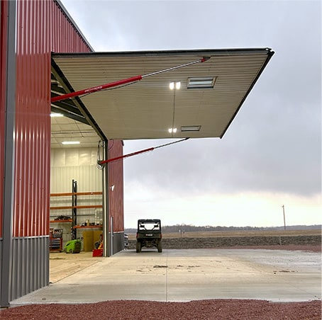 Schweiss hydraulic door installed on a building shown open