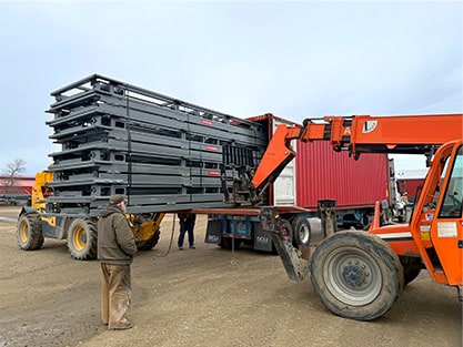 Schweiss Doors being loaded into a shipping container for delivery