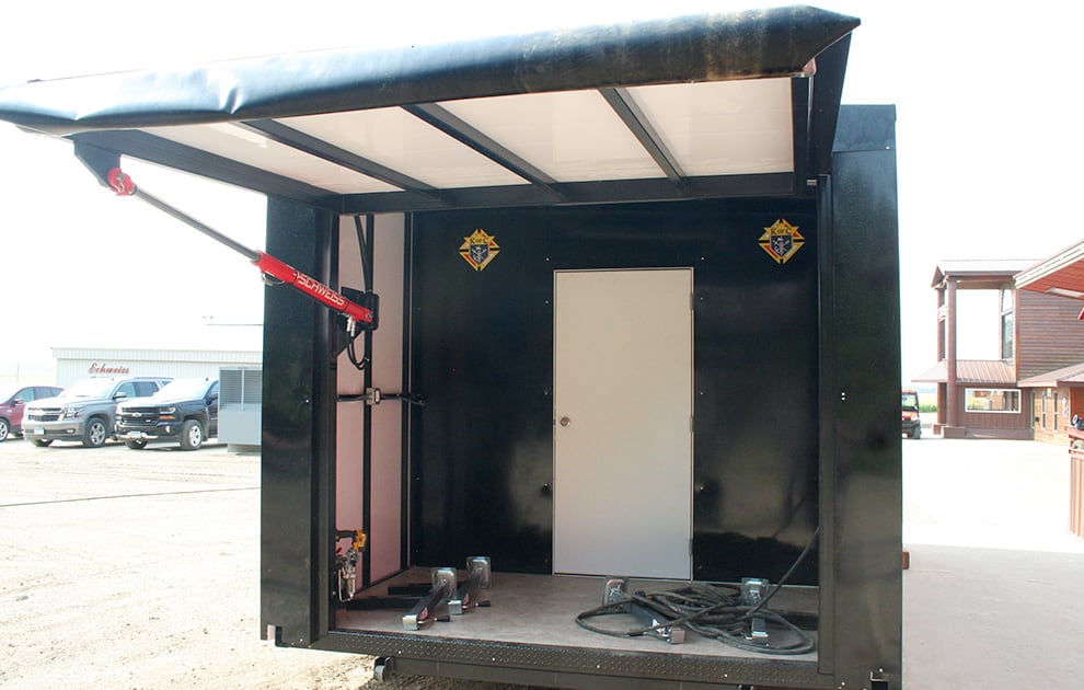 Exterior view of the Knights of Columbus food wagon, showing the manual hydraulic pump from Schweiss