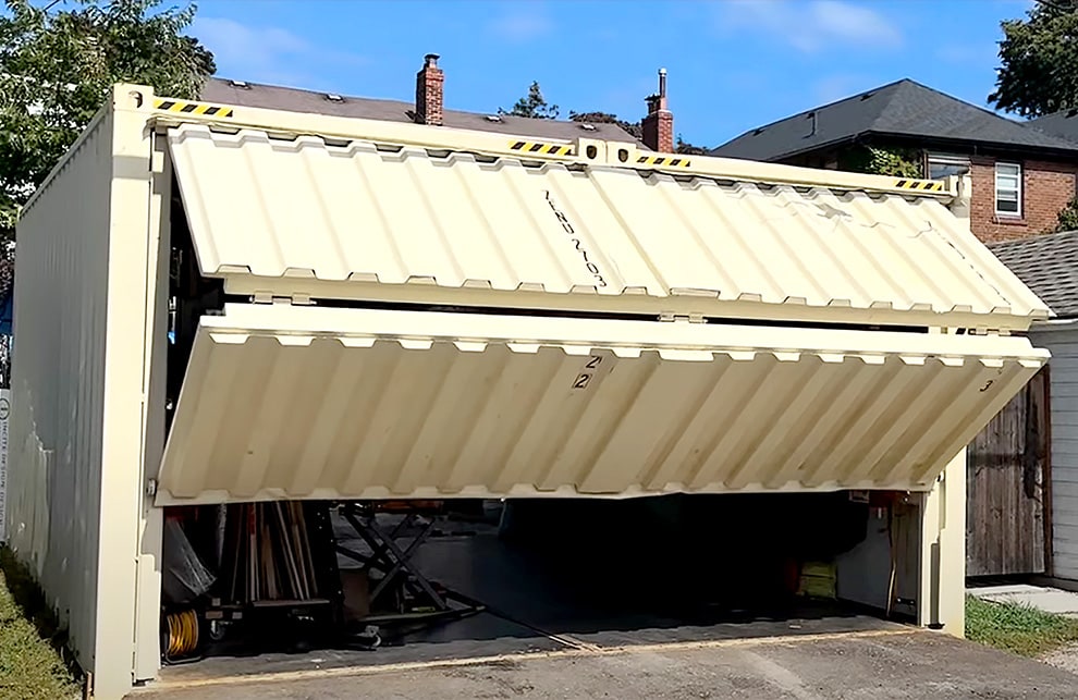 Schweiss bifold container door fitted on Jeffrey Veffer's shipping container garage shown opening angled from the left