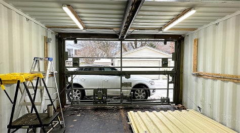 Interior view of Schweiss bifold shipping container door installed Jeffrey's custom garage shown closed