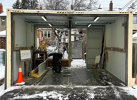 Interior of shipping container garage displaying extra structural support added to accomodate the weight of the Schweiss bifold container door