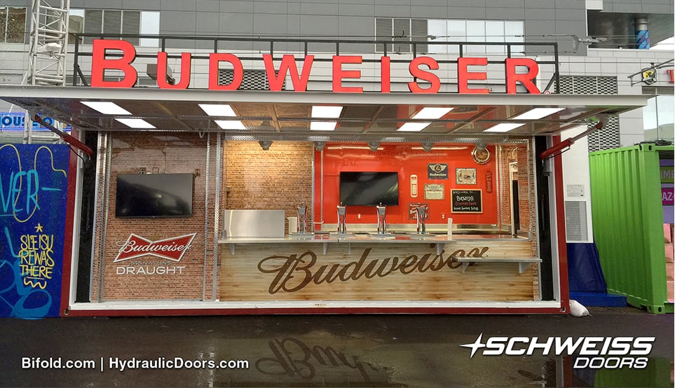 Schweiss Hydraulic Door provide awning for people while in line