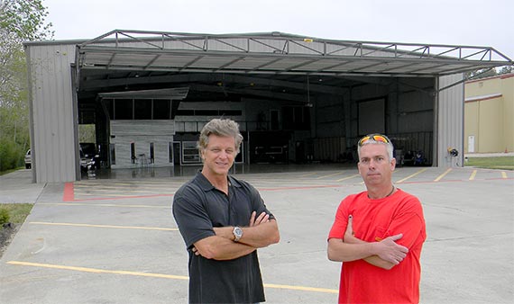 Owner and installer stand infront of Schweiss hydraulic door