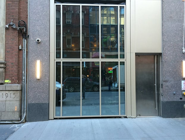 Glass bifold Schweiss door installed on entrance at NYC Hotel