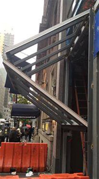 Hotel glass bifold door installation on NYC street