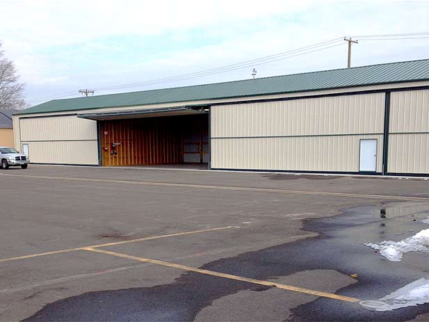 Bifold Hangar door that has walkdoor added in frame