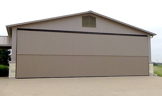 Schweiss hangar home doors in Horseshoe Bay, Texas are used for automobiles and aircraft