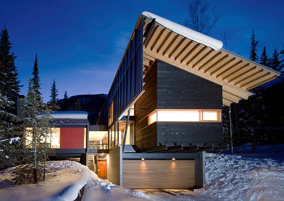 The Red Cedar cladding on hydraulic door matches the exterior of the resort home perfectly