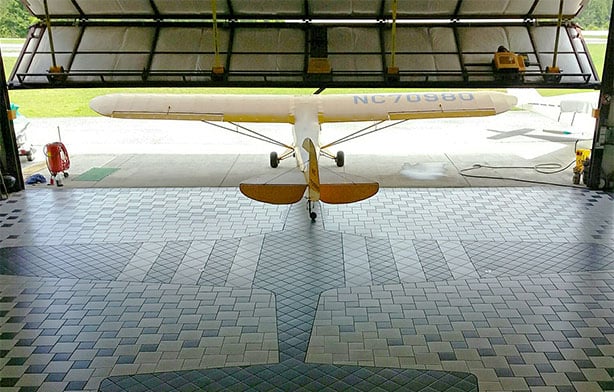 Full scale inlaid replica of a P-51 Mustang and large Schweiss bifold door show off hangar in Tennessee