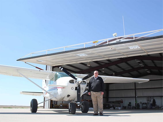 Stan Reiss stands proudly infront of large hydraulic door windrated 90mph for Kansas