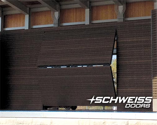 Schweiss Stage Door is clad in pressure treated added to hold cedar slats