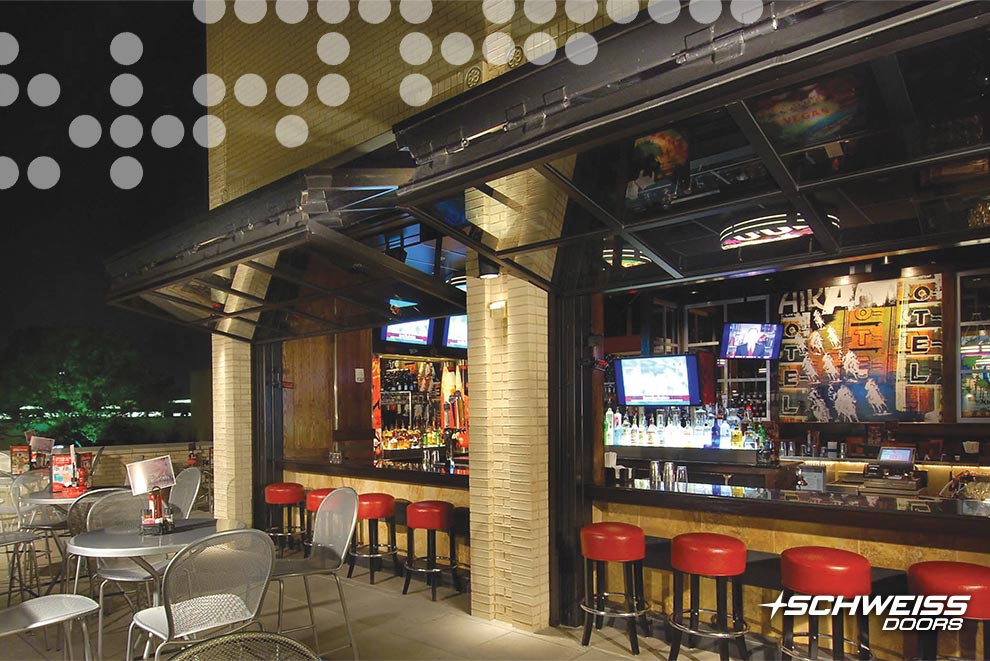 Schweiss bifold doors open bar to customers on the restaurant patio