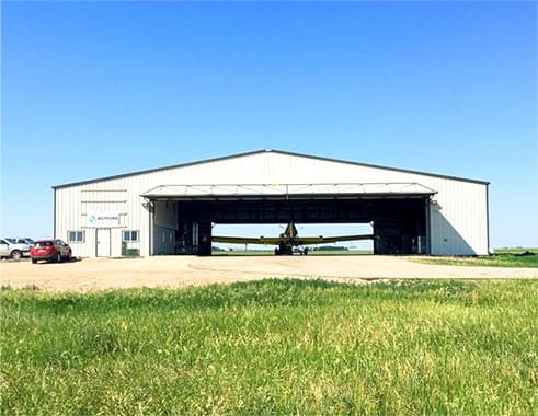 Distanced view of multiple Schweiss hydraulic doors fitted on Agtegra Cooperative Aerial Spraying Division