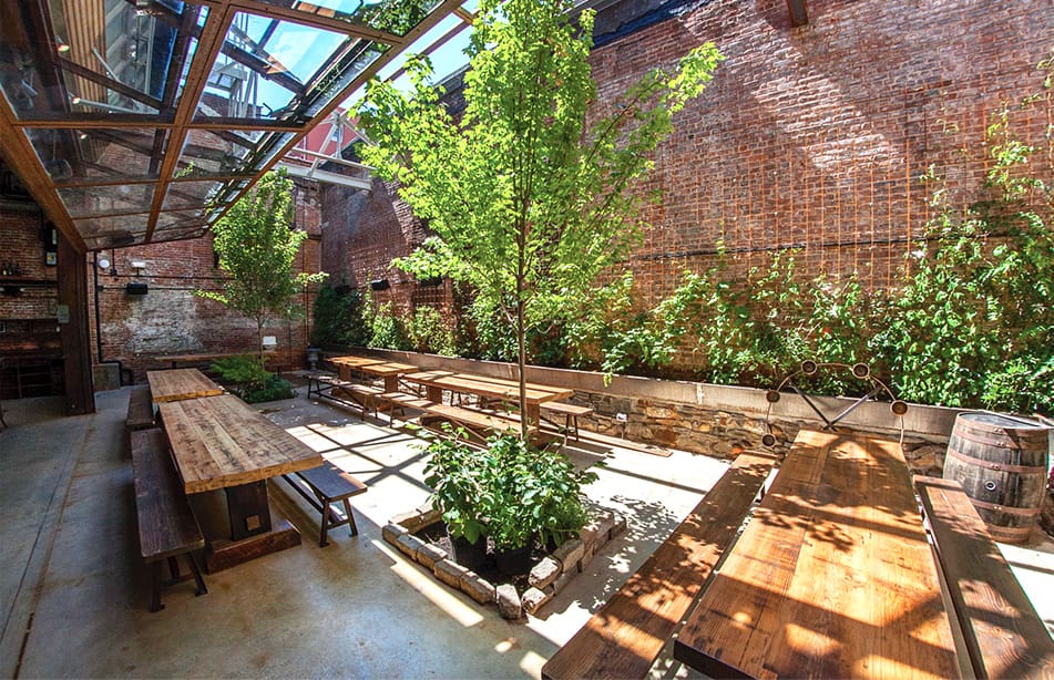 Viewing of the outdoor backyard patio of 76 Ainslie underneath their Schweiss glass bifold door