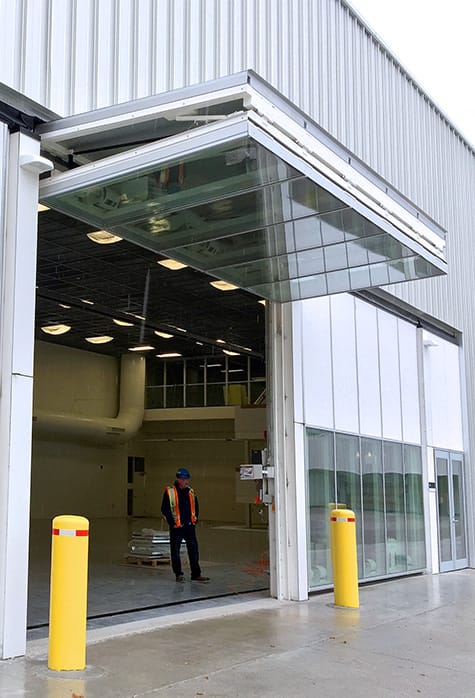 Side view of one of the custom Schweiss glass bifold doors installed on a Canadian Forces Base in Ontario
