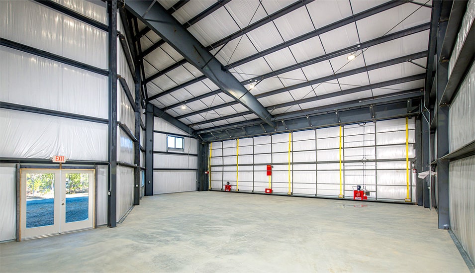 Interior view of Schweiss bifold door fitted on custom auto mechanic shop shown closed