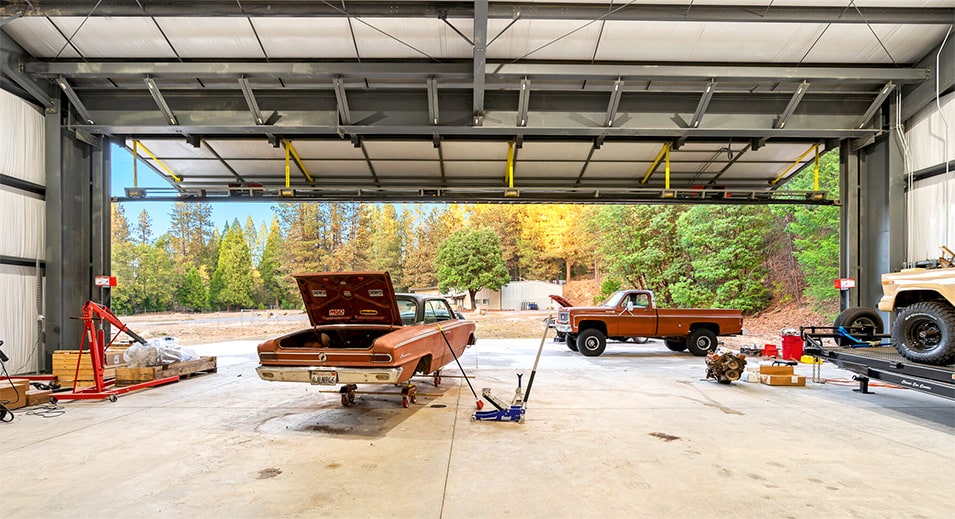 Interior view of Schweiss bifold door fitted on custom auto mechanic shop shown open