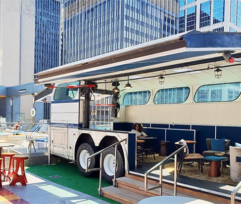 View of the Schweiss hydraulic door fitted on the side of the Greyhound bus on top of Bobby Hotel